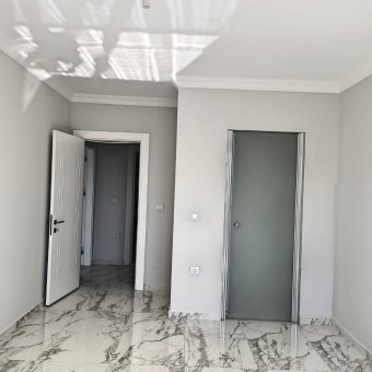 Ayvalık Güzelbahçe Evlerinde Satılık Lüks Deniz Manzaralı 1+1 Sıfır Daire.